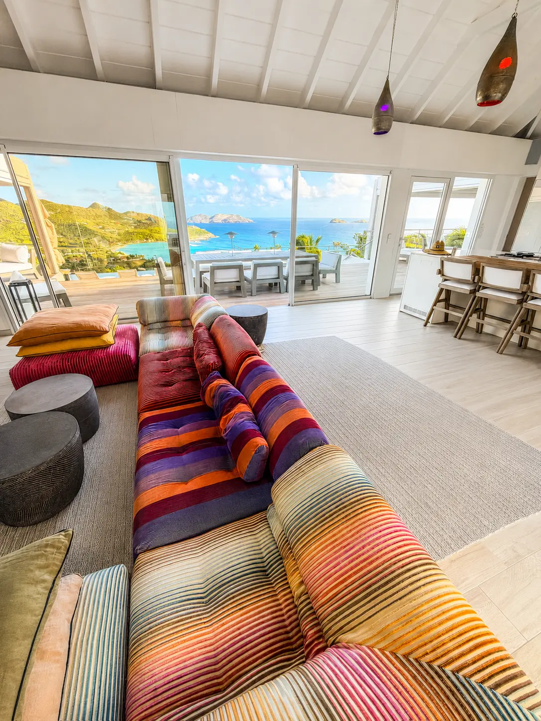 Open living room with sliding doors framing the terrace and the sea