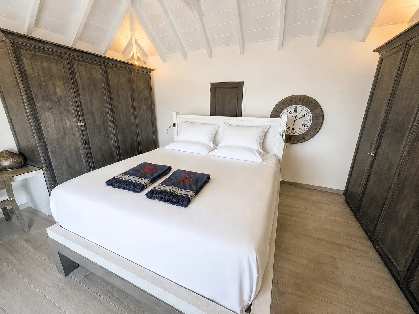 King bedroom suite with vaulted ceiling and wood armoires