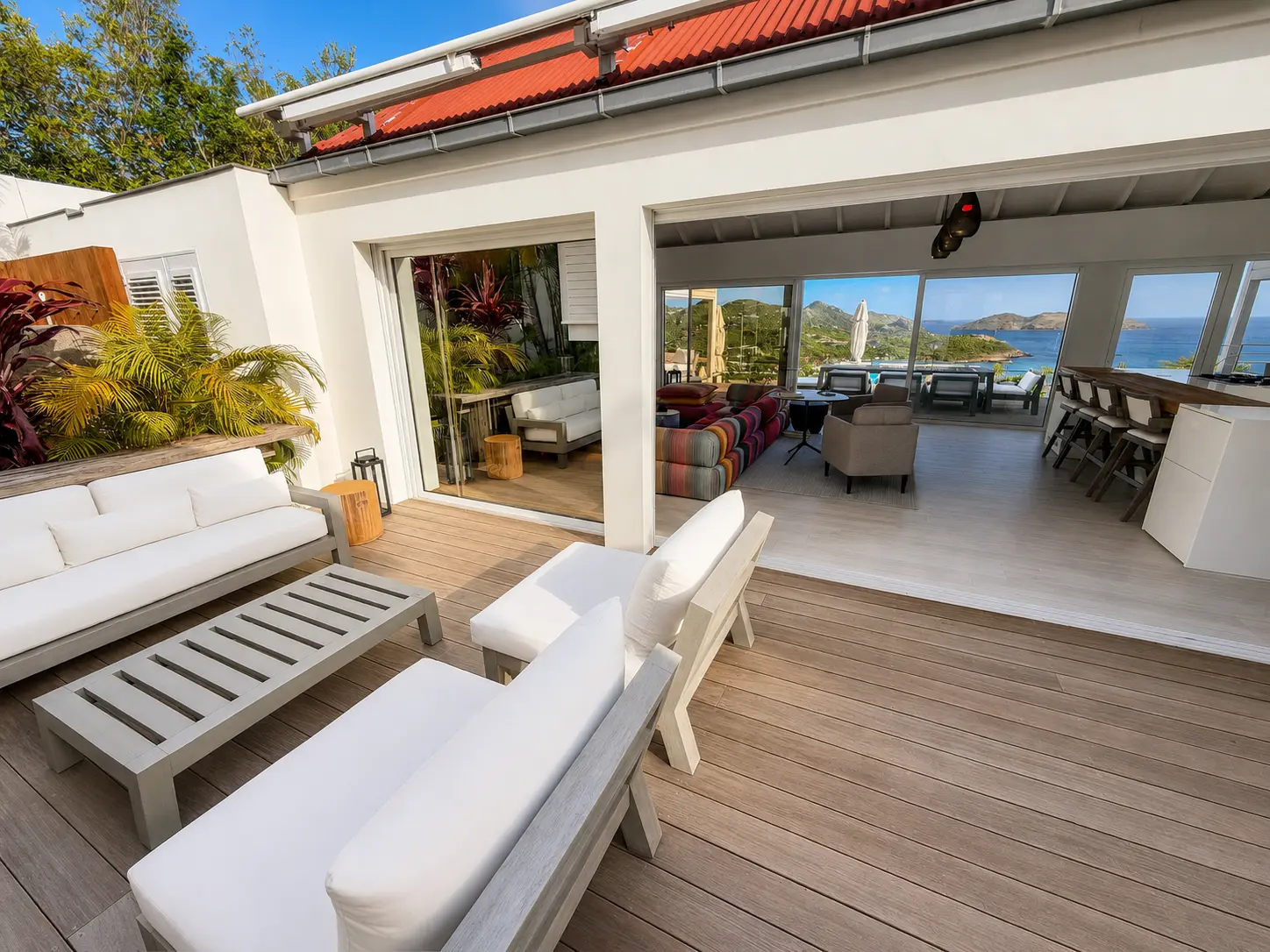 Deck with outdoor sofas leading into the open living and kitchen space