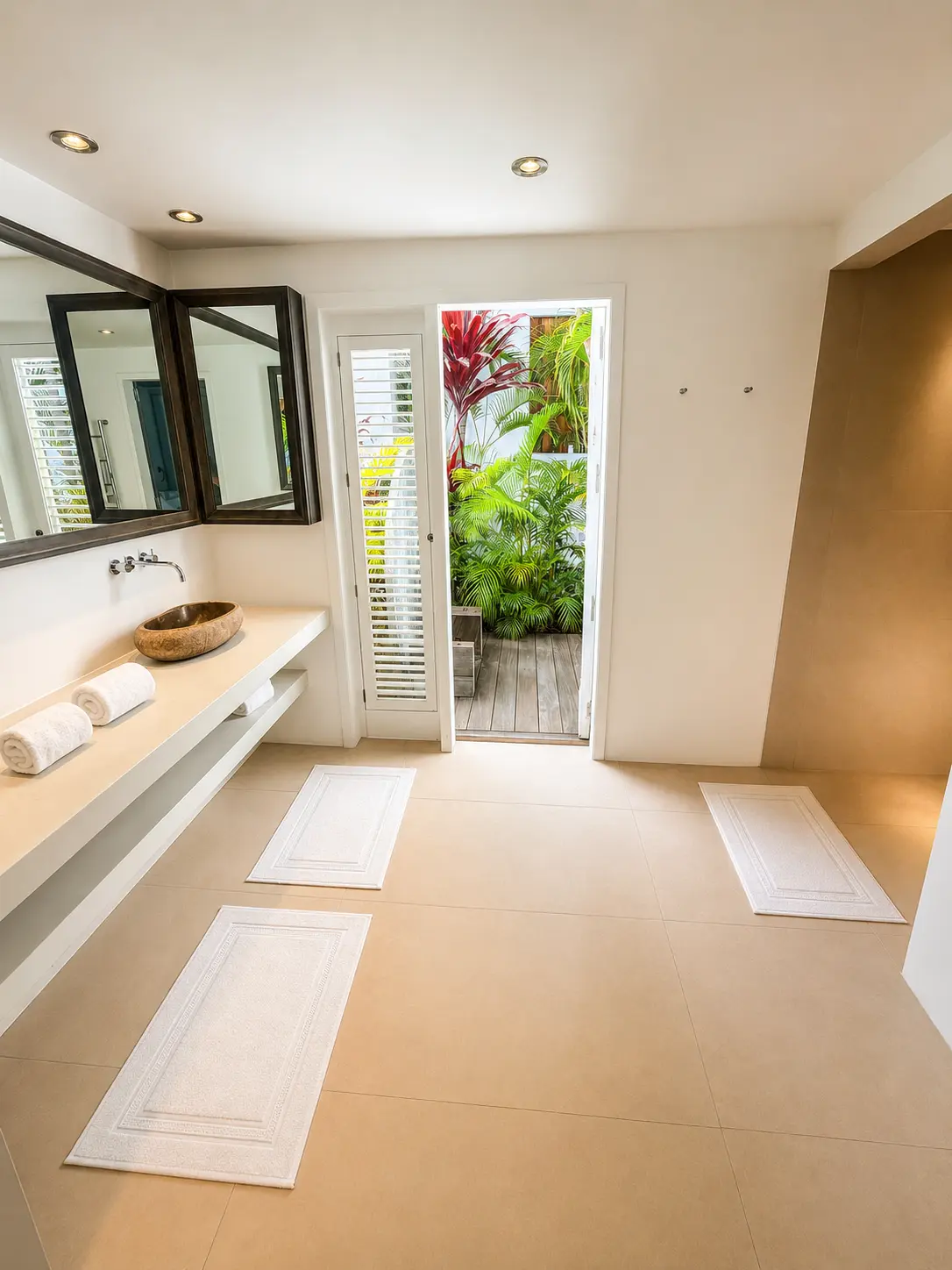 Bathroom with stone vessel sinks and outdoor garden access
