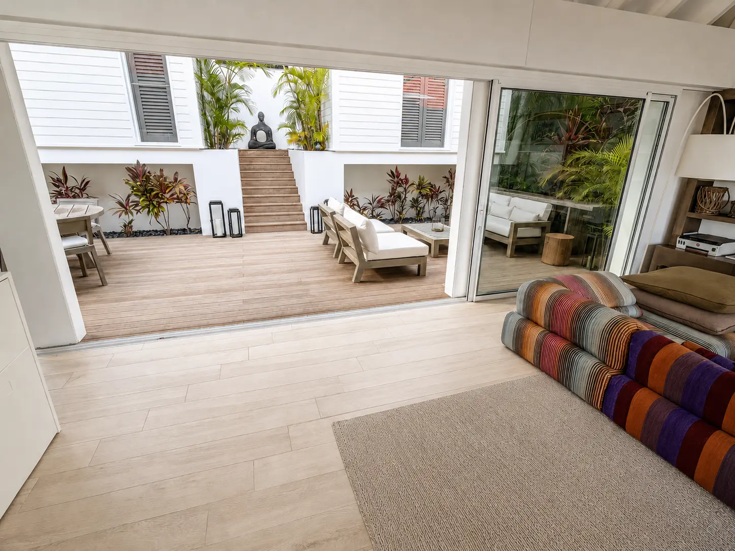 Living room opening onto the planted courtyard deck
