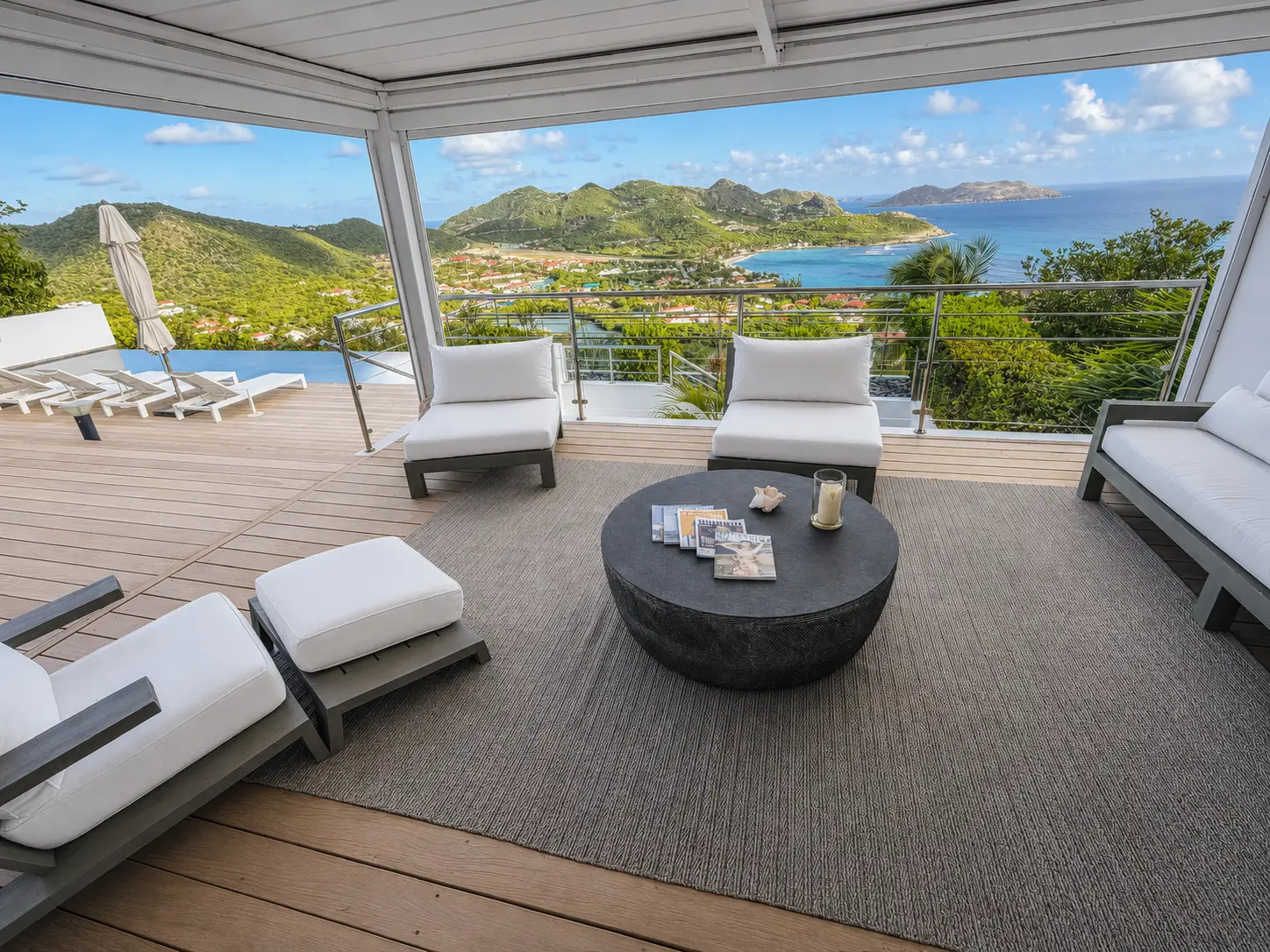 Ocean-facing pergola lounge beside the infinity pool overlooking St. Jean Bay