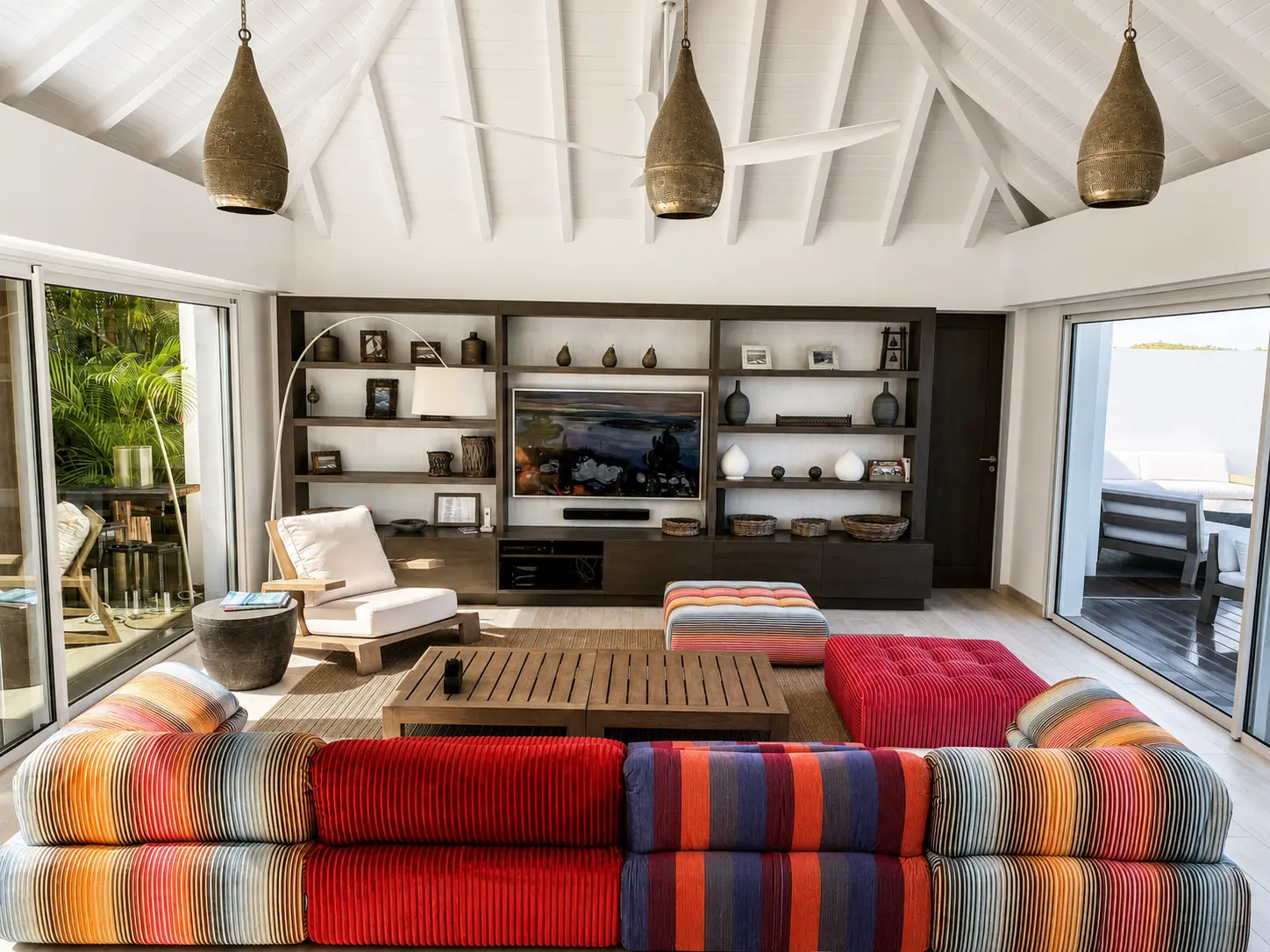 Living room with colorful sofa facing the television mounted on the back wall